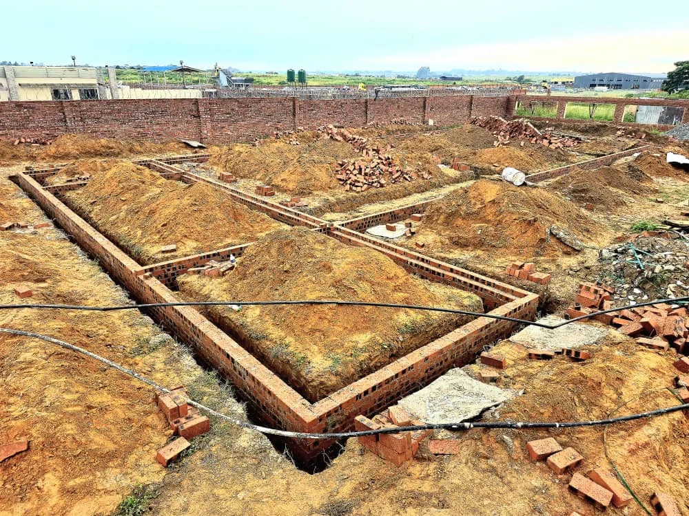 Brick foundation walls set out in their trenches for Upgrade Projects' own offices